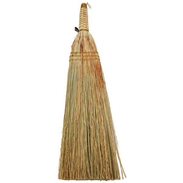 Broom with a natural straw bristle head and wooden handle on a white background